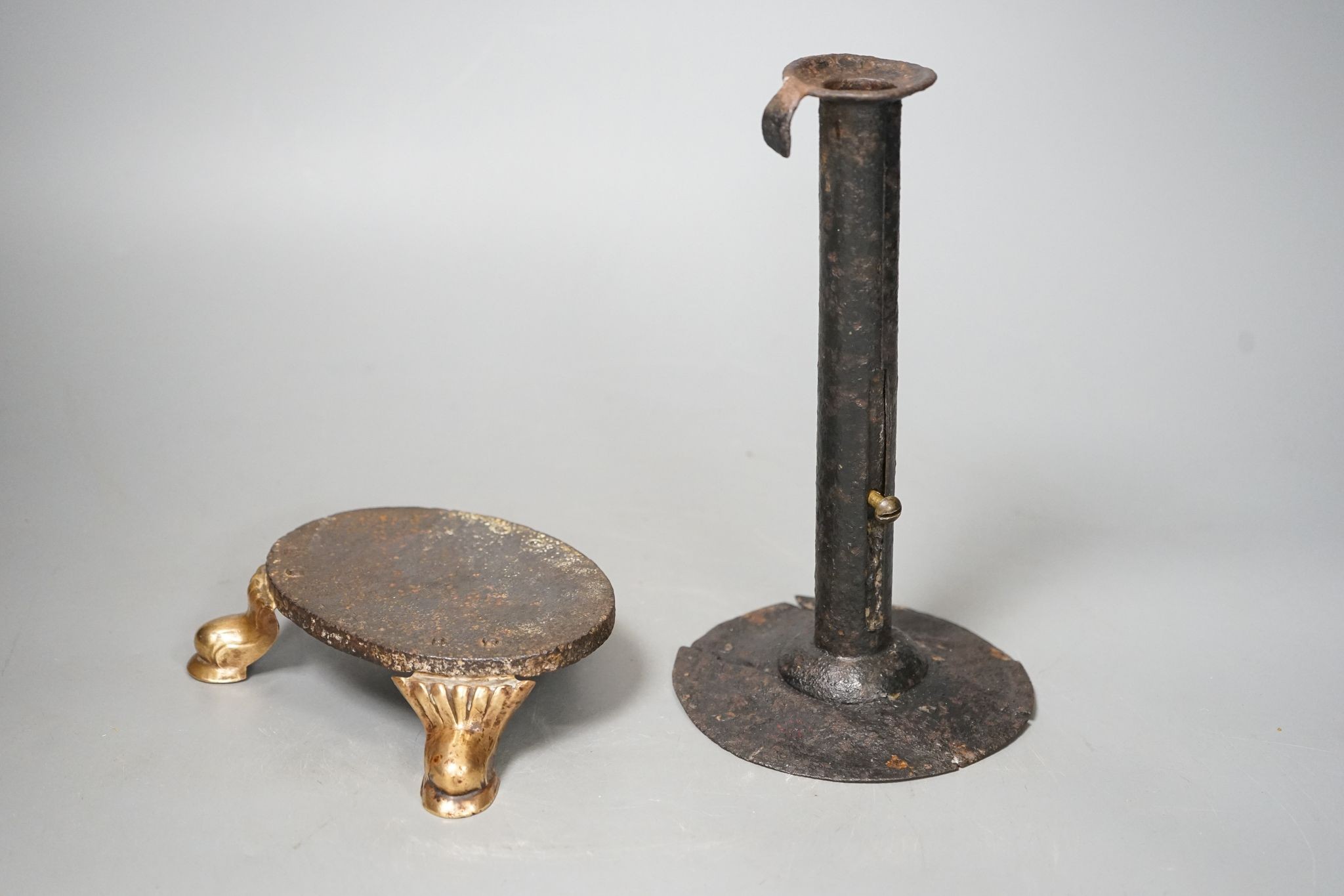 An 18th century provincial tole candlestick and an 18th century iron and brass oval stand, candlestick 20cm